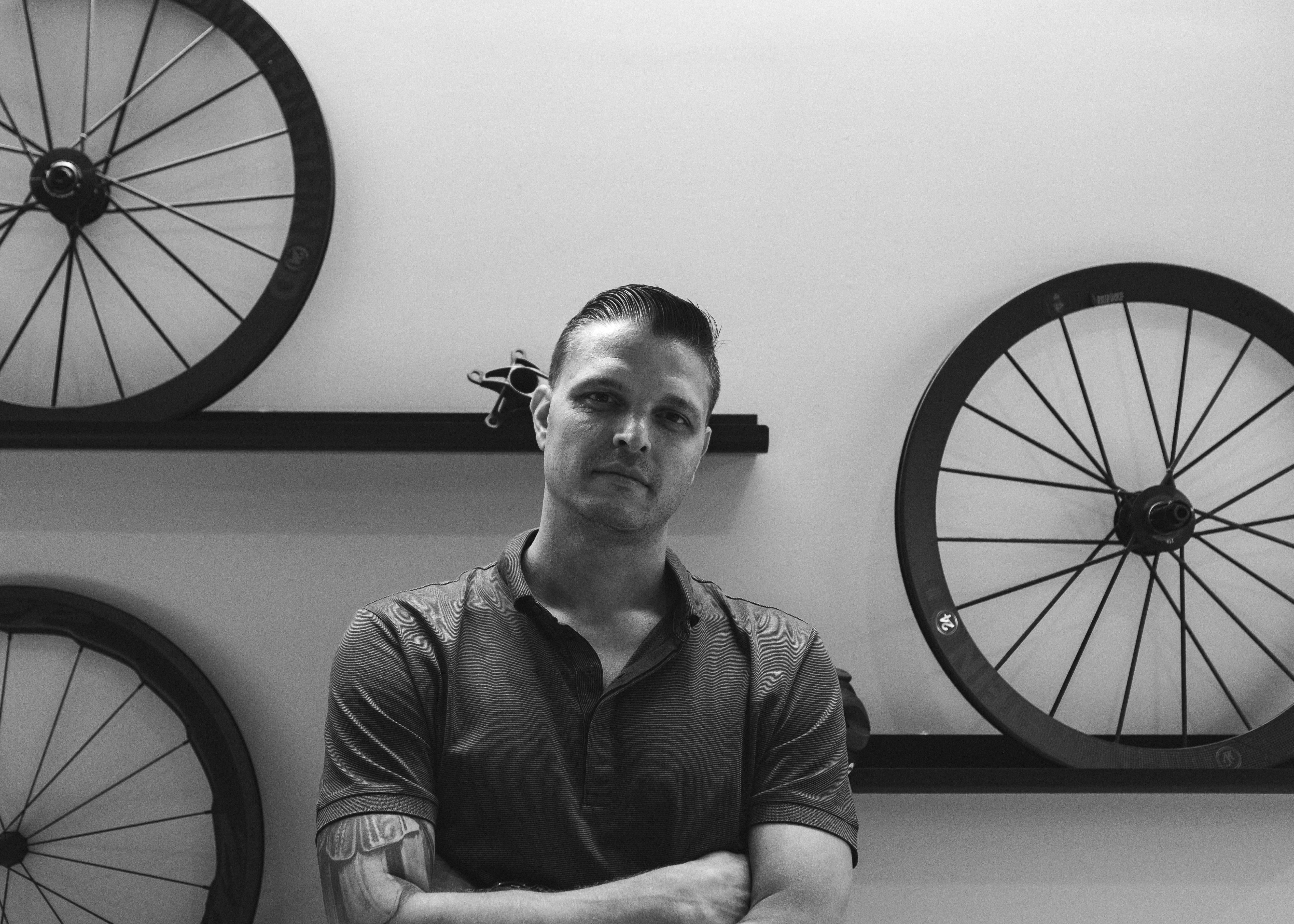 Albert Cabbad, son of founder Philip Cabbad, seated in front of high-performance carbon cycling wheels at RA Cycles headquarters